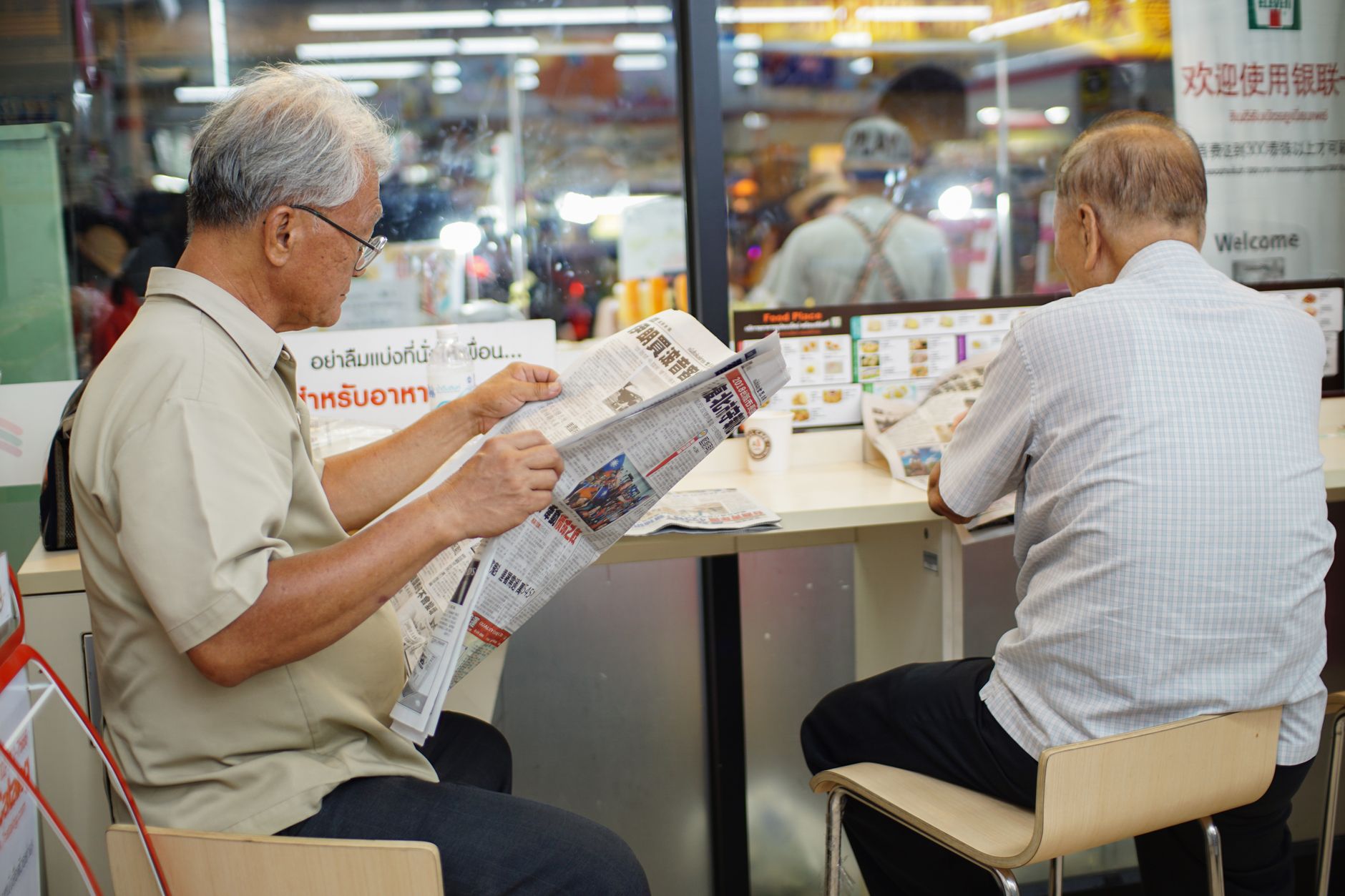 Stack of British Sunday newspapers on a cafe table, illustrating british sunday newspapers circulation 2026