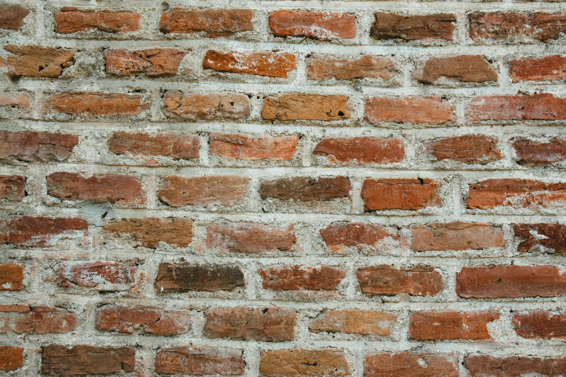 Close-up of crumbling and recessed mortar joints on a brick wall, showing why repointing brick wall cost UK 2026 matters